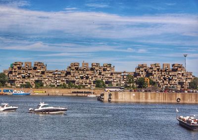 Boats in river with buildings in background