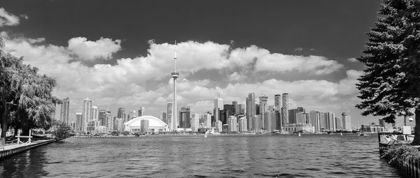Panoramic view of buildings against cloudy sky