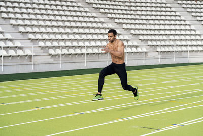 Full length of man running at sports field