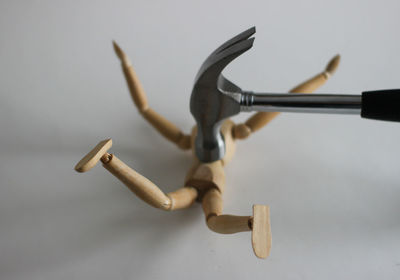 Close-up of figurine on table against white background