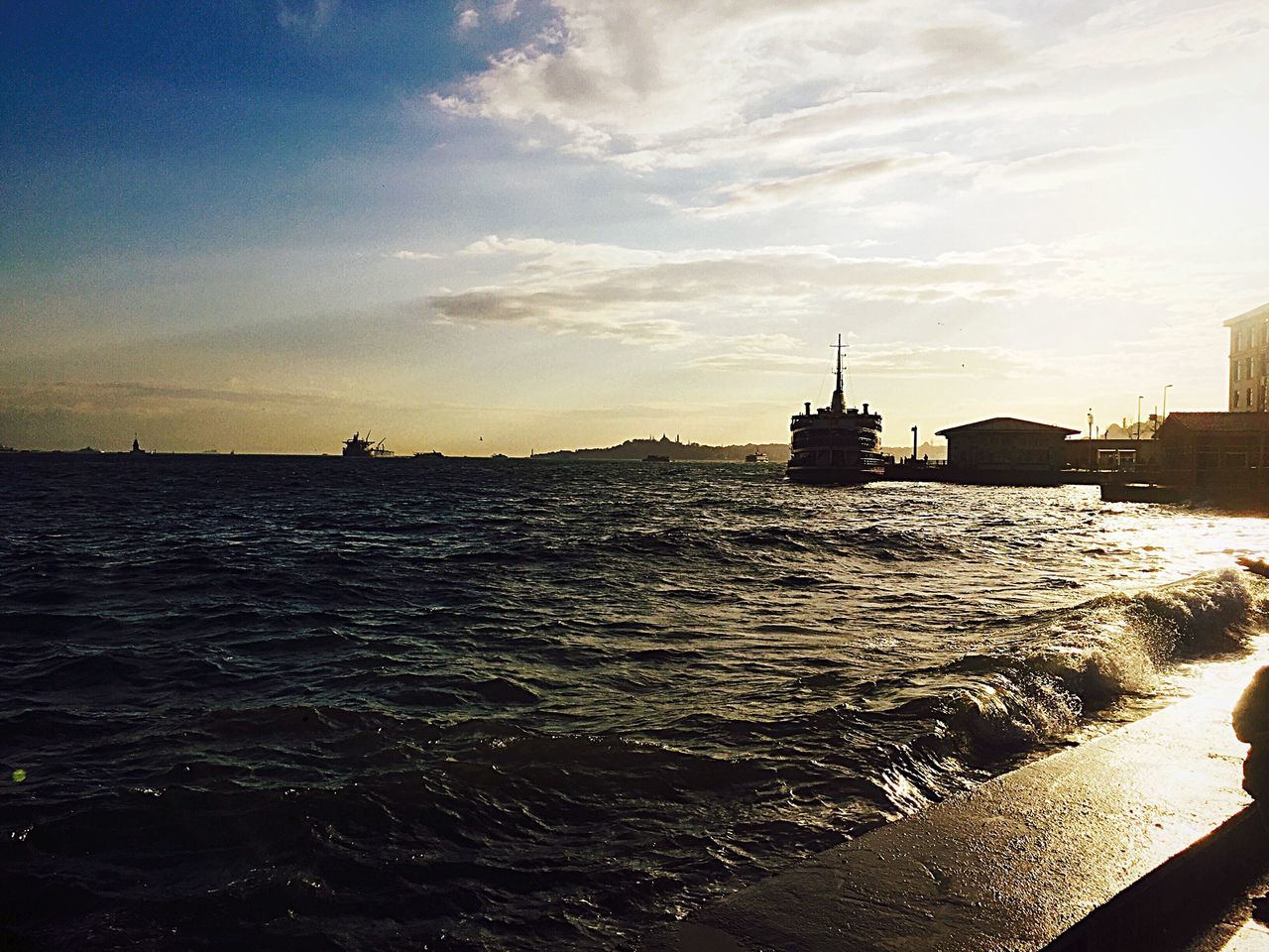 water, sea, sky, nautical vessel, transportation, waterfront, mode of transport, rippled, boat, horizon over water, scenics, built structure, cloud - sky, tranquil scene, nature, tranquility, beauty in nature, sunset, sailing, building exterior