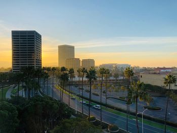 City by buildings against sky during sunset
