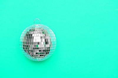 Low angle view of crystal ball against blue background