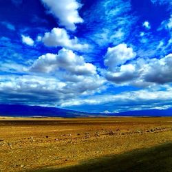 Scenic view of landscape against cloudy sky