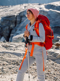 Portrait of young woman standing on snow