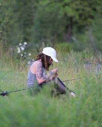 Woman wearing hat on field