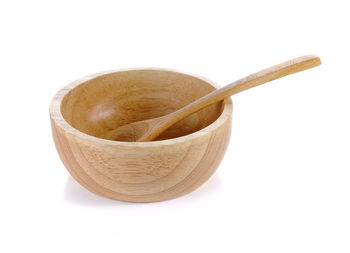 Close-up of bread in bowl against white background