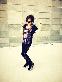 Full length of woman standing on wall