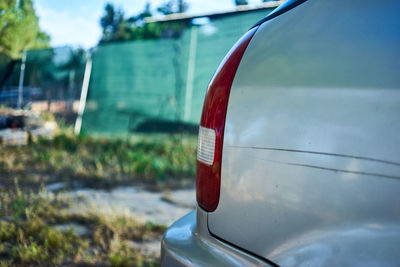 Close-up of red car on road