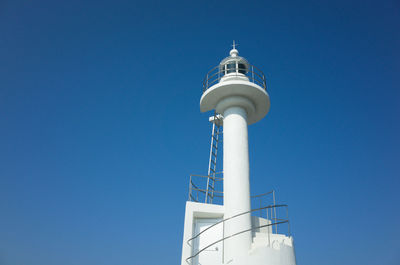 Low angle view of lighthouse against clear blue sky