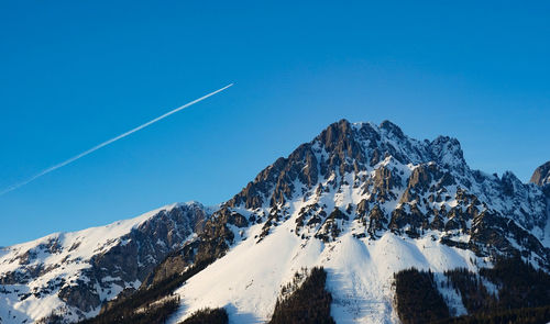 Scenic view of snowcapped mountains against clear blue sky