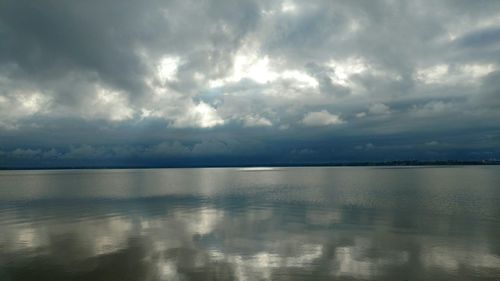 Scenic view of sea against storm clouds