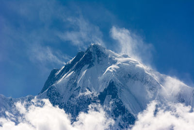 Aerial view of snowcapped mountains against sky