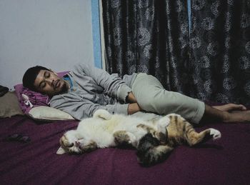 Cat sleeping on bed at home