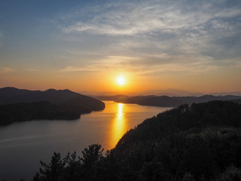 A perfect sun setting seen from a mountain over a huge lake