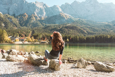 Rear view of woman looking at lake