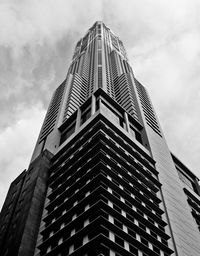 Low angle view of modern building against cloudy sky