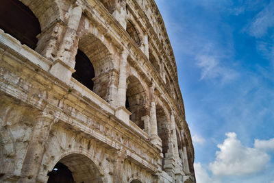 Low angle view of historical building against cloudy sky