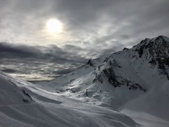 Scenic view of snow covered mountains against sky