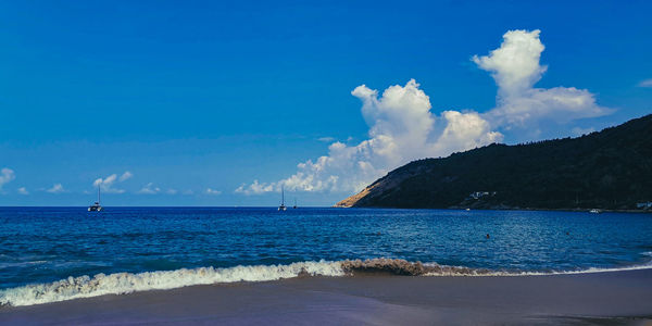 Scenic view of sea against blue sky