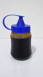 Close-up of water bottle on table against white background