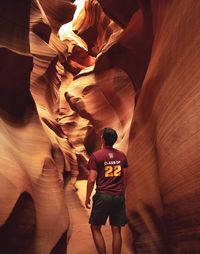 Rear view of man standing on rock