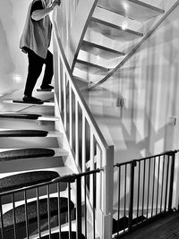 Low section of woman standing on staircase