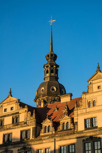 Low angle view of clock tower against blue sky