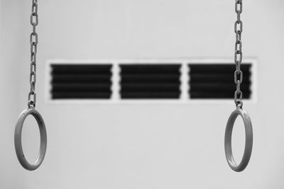 Gymnastics rings hanging against wall