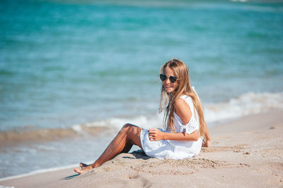 Young woman sitting on beach