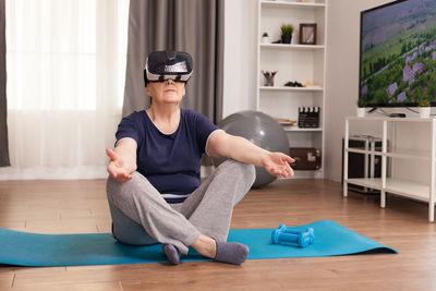 Man exercising while wearing virtual reality headset