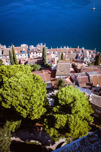 High angle view of townscape by sea against sky