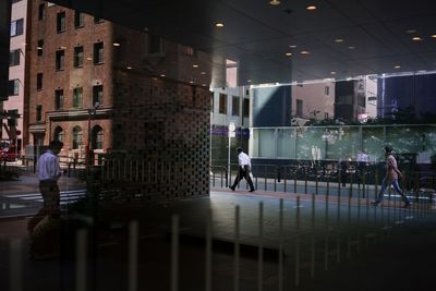 Woman standing in illuminated city at night