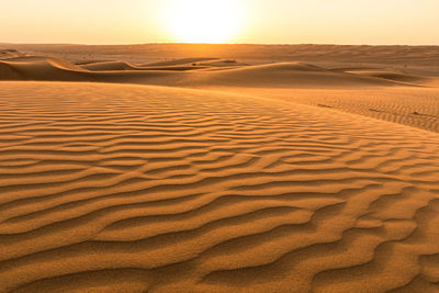 Scenic view of desert against sky during sunset