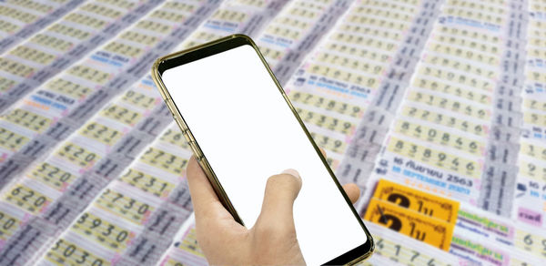Close-up of hand holding mobile phone