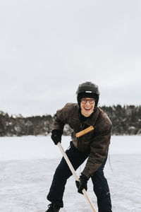 Man ice-skating on frozen lake