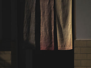 Close-up of curtain hanging on window of house