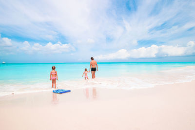 People on beach against sky