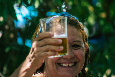 Close-up portrait of a man drinking glass