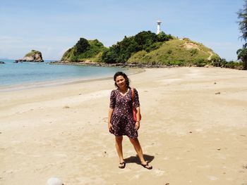 Portrait of woman standing at beach