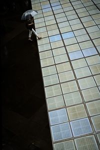 High angle view of woman walking on tiled floor