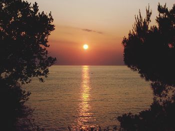 Scenic view of sea against orange sky