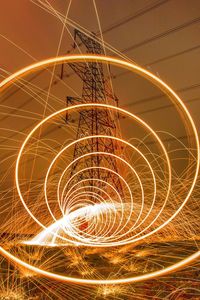 Close-up of light trails against sky at night