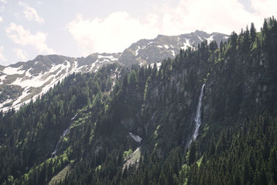 Scenic view of mountains against cloudy sky