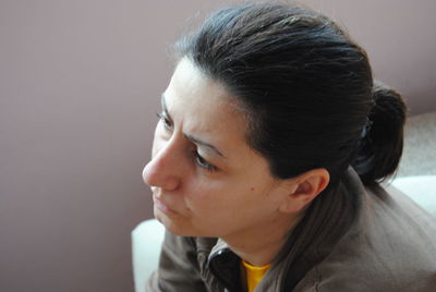 Close-up of thoughtful woman at home