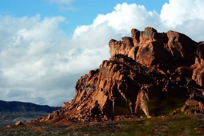 Rock formations on landscape against sky