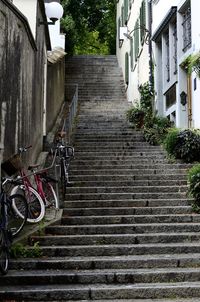 Staircase by building in city against sky