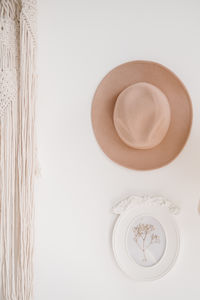 High angle view of hat on table against white background