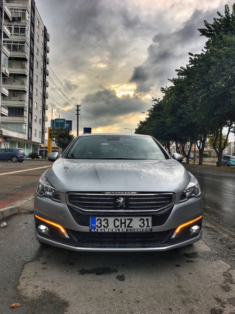 CAR ON STREET AGAINST SKY