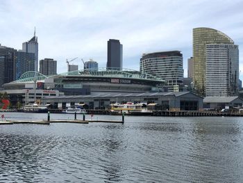 View of buildings in city against cloudy sky